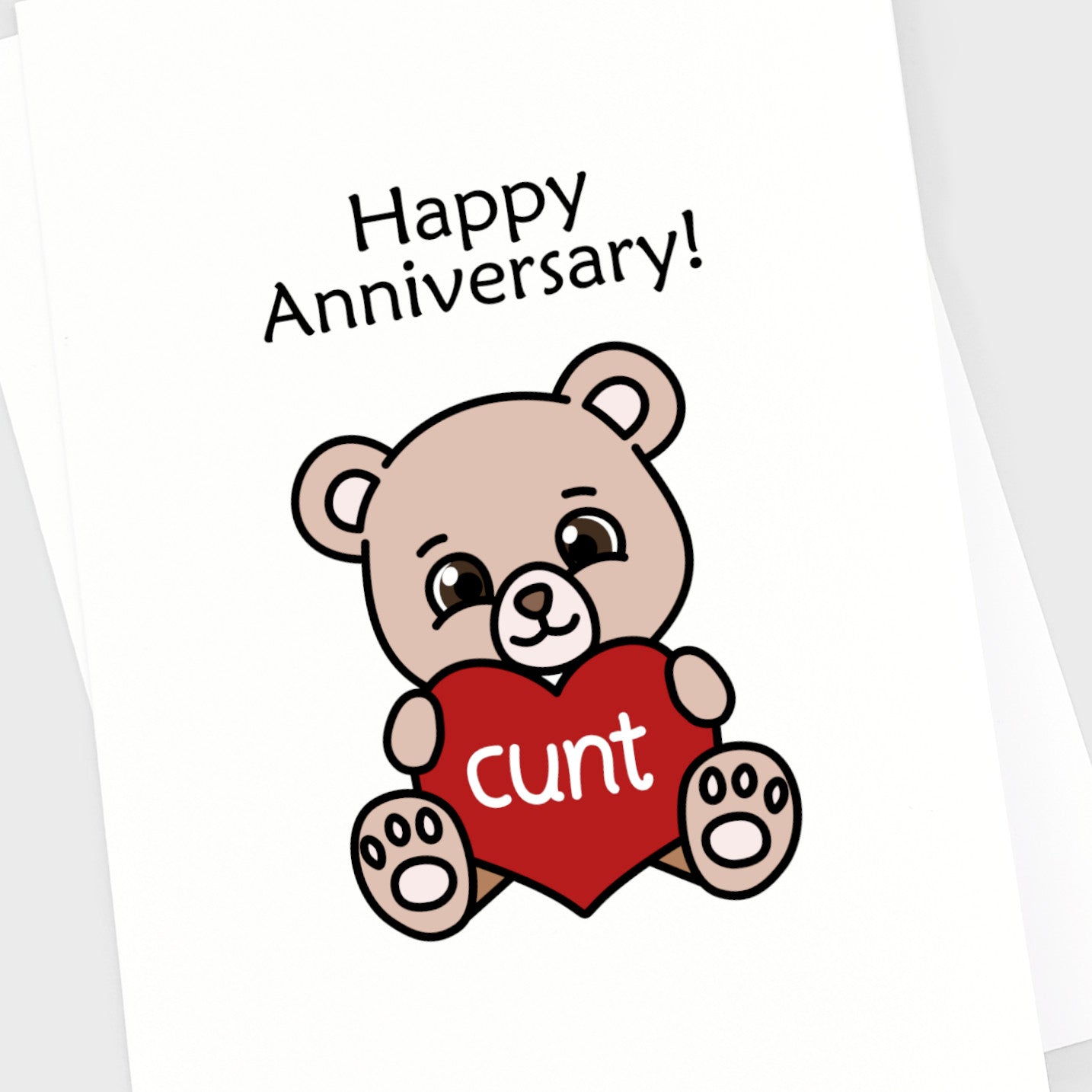 Close up of an anniversary card with a cute bear holding a heart with CUNT written in it.